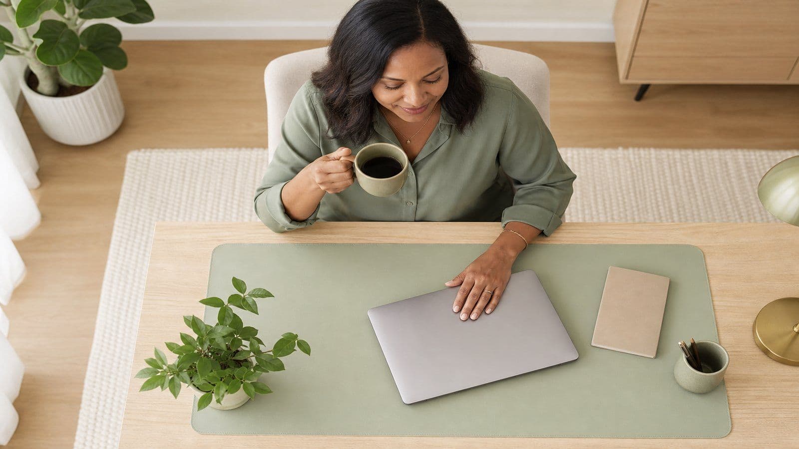 A small-business owner reviews her monthly numbers at a calm home desk